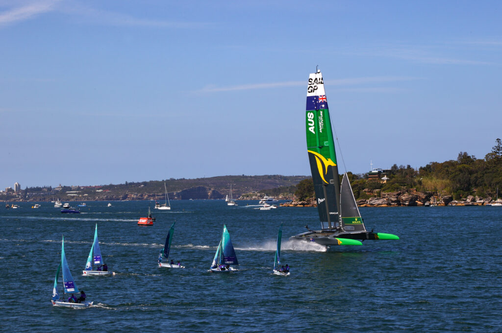 Australian F50 on foils, passing Feva dinghies in Rose Bay.