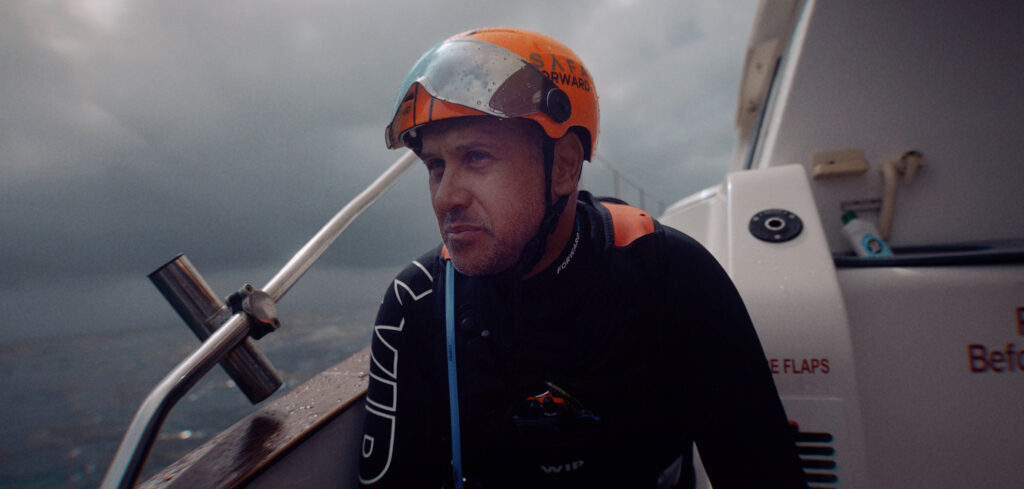 Andrew Englisch with his helmet on, aboard a boat.