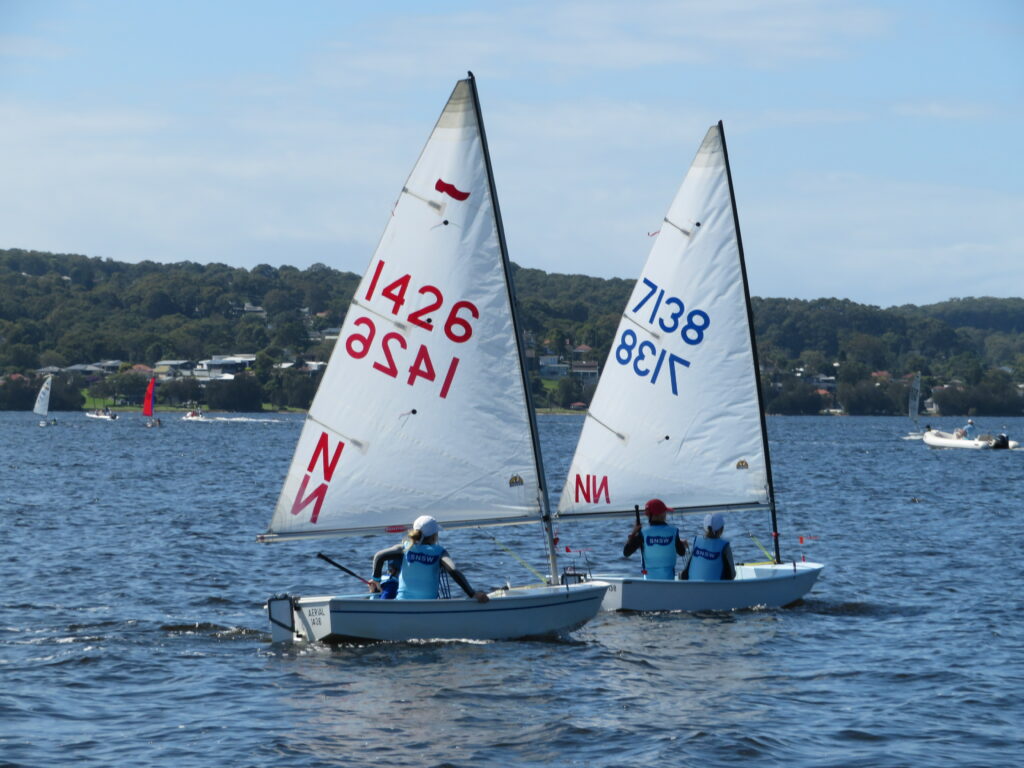 Two boats behind each other and almost windward leeward sailing upwind.