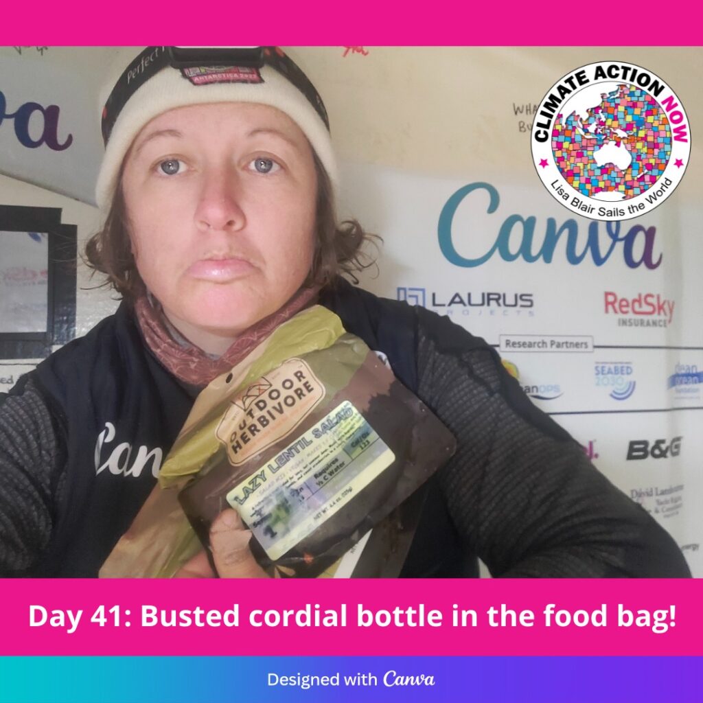 Lisa Blair selfie - frowning while holding food packet soaked in cordial.