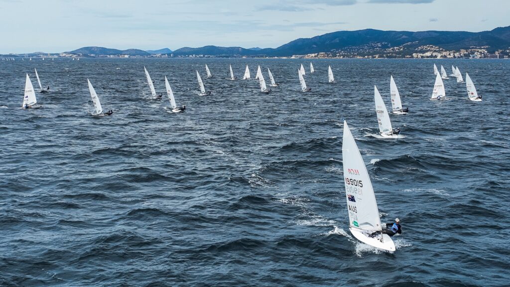 Laser fleet sailing upwind led by Wearn.