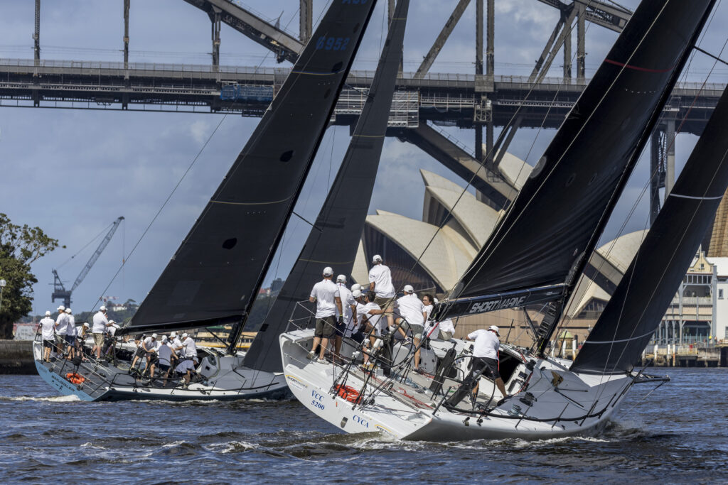 Two boats sailing upwind (windward leeward) towards Harbour Bridge and Opera House.