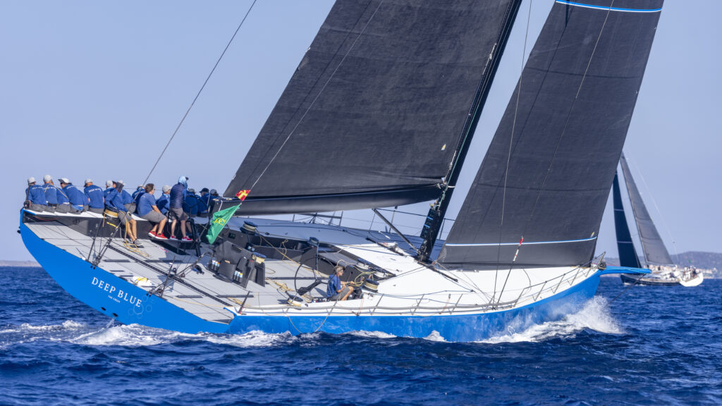 Blue yacht sailing upwind.