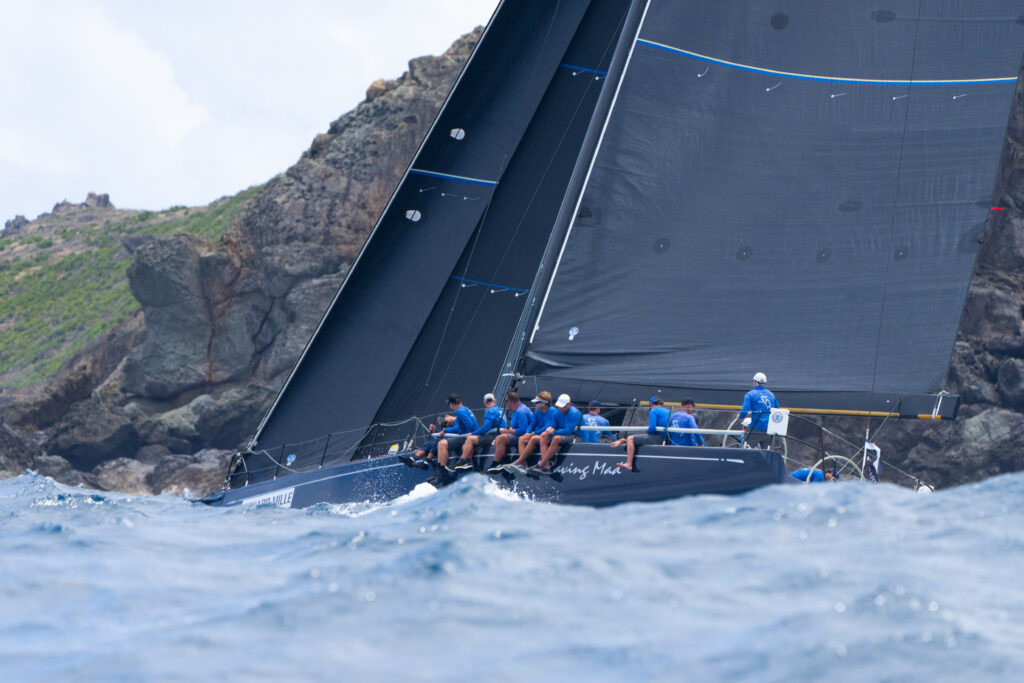 Stark Raving Mad VII sailing upwind in big swell.