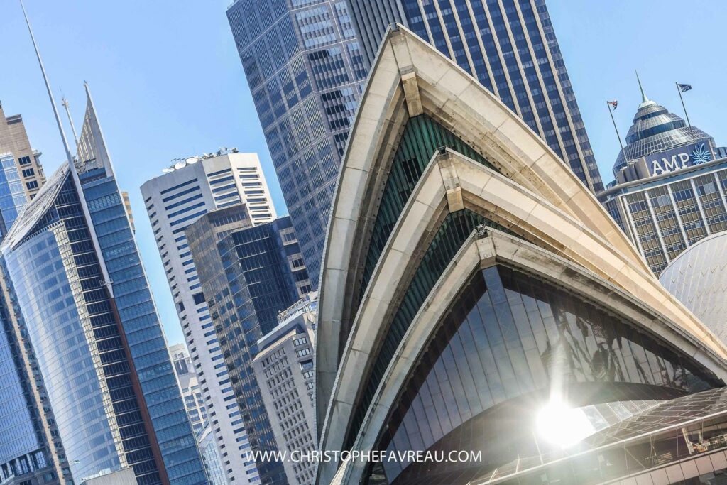 The top of the Opera House with city in the background.