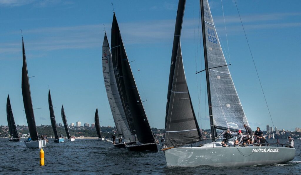 Fleet sailing upwind to top mark.