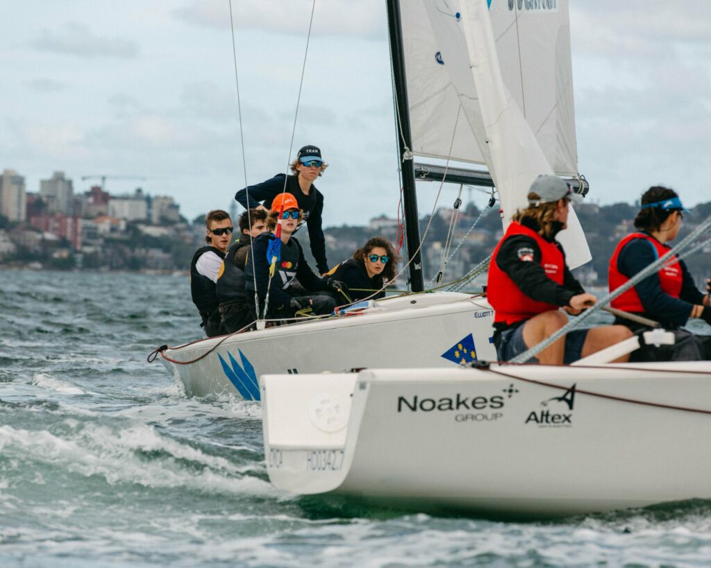 Two boats sailing downwind on different tacks.