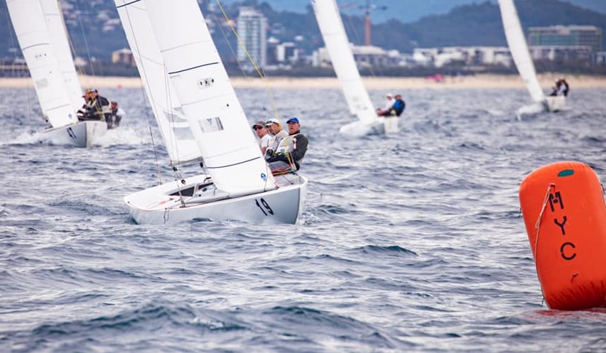 Fleet sailing upwind to top mark.