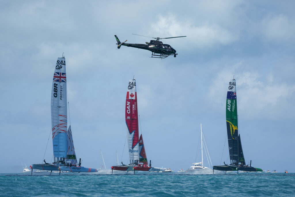 Australia, Canada and GBR sailing upwind with a helicopter above.