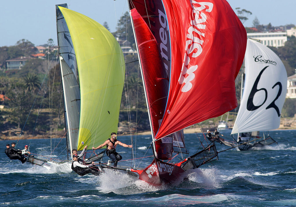 Smeg on kite reach with two boats behind them.