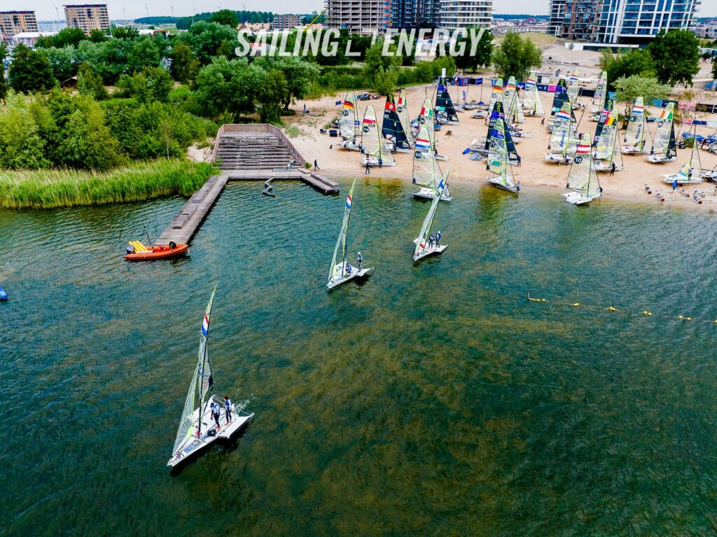 Aerial shot of 49er fleet leaving the beach in no wind.