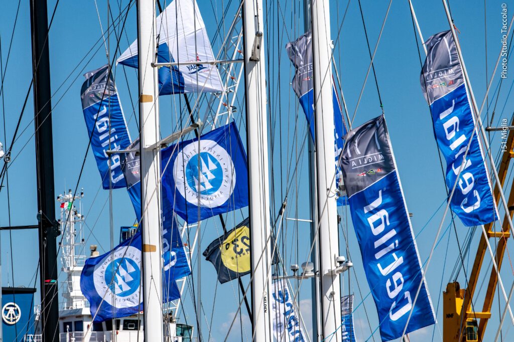 Flags handing from various rigs on the dock.