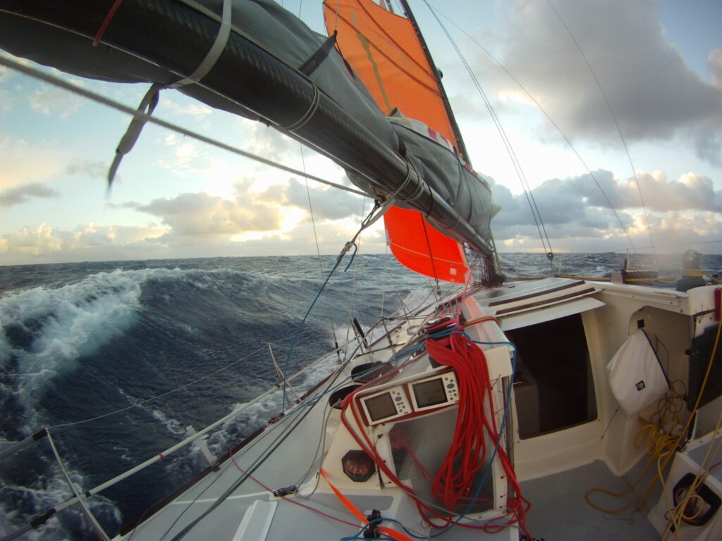 Perspective from cockpit as boat sailing with storm sails.