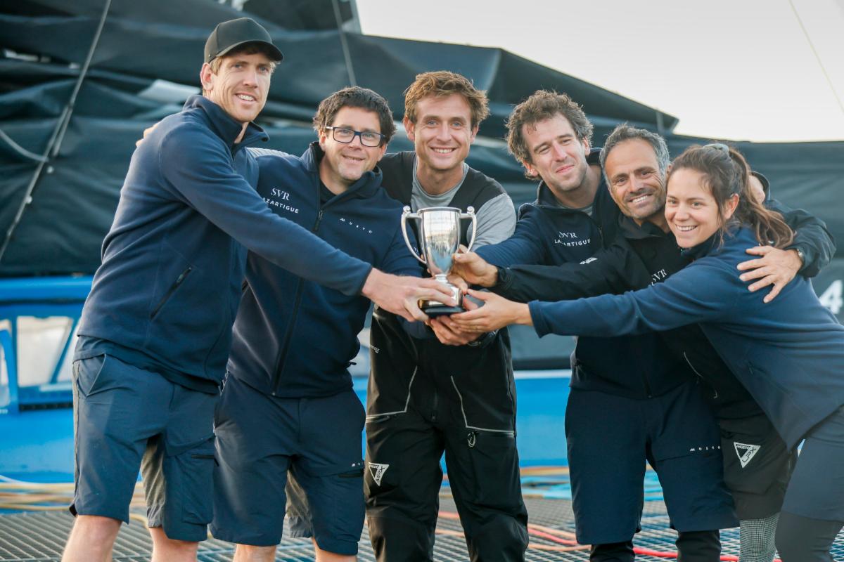 Peter Burling and the crew of SVR Lazartigue celebrate multihull line honours win  © Paul Wyeth/RORC 