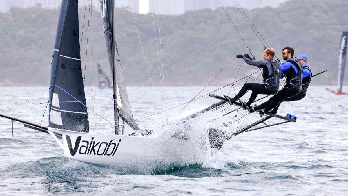 Crew works hard on a spinnaker run (SailMedia)