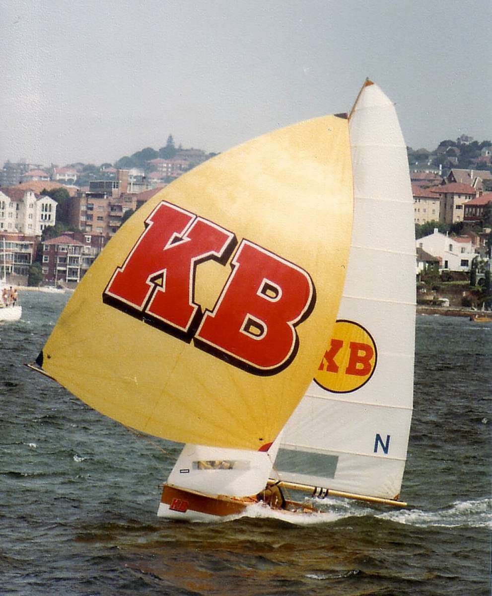 Familiar sight of KB skiff with the gold spinnaker & red KB logo (Frank Quealey)