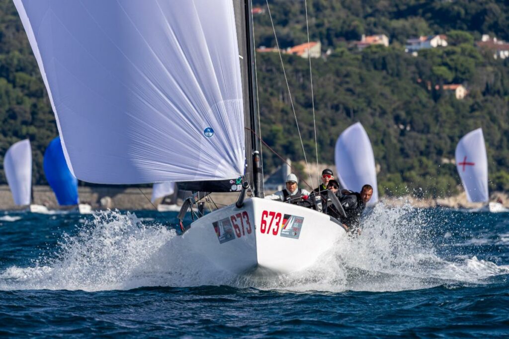 Peter Karrie's NEFELI (GER) with Alessandro Franci, Niccolò Bianchi, Saverio Cigliano, and Karlo Hmeljak, supported by coach Simon Sivitz Kosuta - Melges 24 World Championship 2025, Trieste, Italy © YCA | Giovanni Tesei