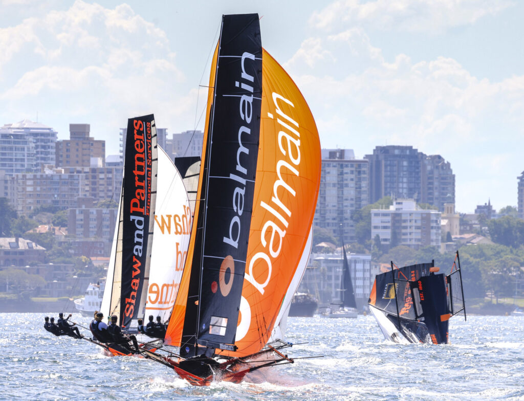 Challenging for the lead as previous leader has a nose dive capsize (SailMedia)