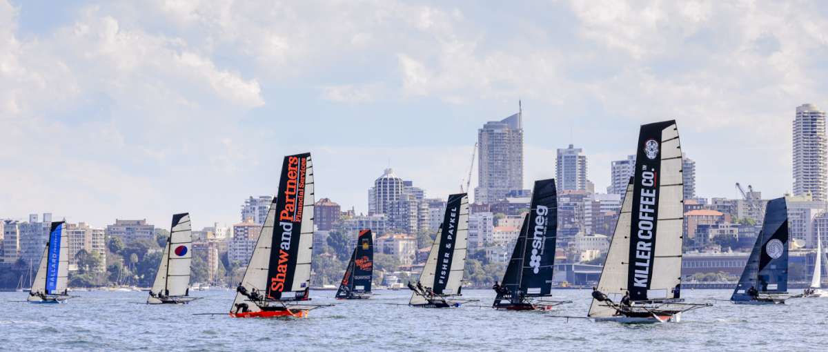 Bec's Sotheby's Balard Property leads the fleet across the harbour (SailMedia)