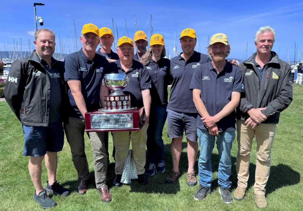 Alien, overall winner of the 2025 Melbourne to Hobart Yacht Race, awarded the Heemskerk Perpetual Trophy, with ORCV Race Director Ravid Schuller (L) and ORCV Commodore Cyrus Allen (R ). Photo credit Jane Austin