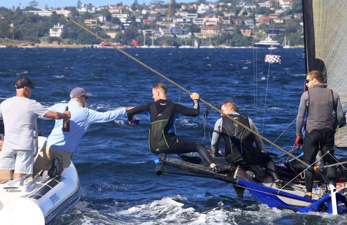 Blue ribbon handed to Yandoo's winning crew by 1996 champion Stephen Quigley (SailMedia)