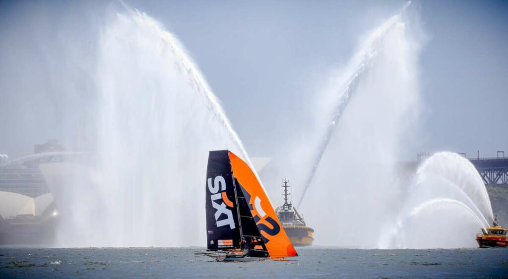 Sixt skiff in front of a Sydney Harbour water spray (SailMedia)