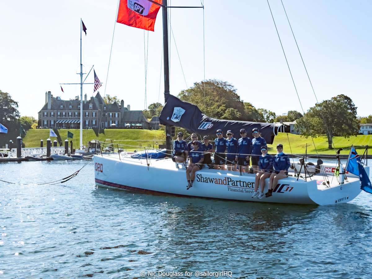 The full team on their IC37 in front of the NYYC, Newport RI - Credit - Sunset Media - @sailorgirlhq