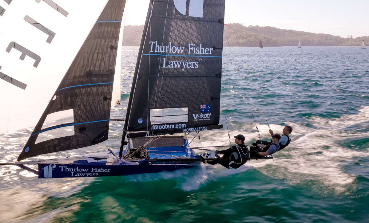 The Thurlow Fisher Lawyers crew drive the skiff hard on the first spinnaker run last Sunday (SailMedia)