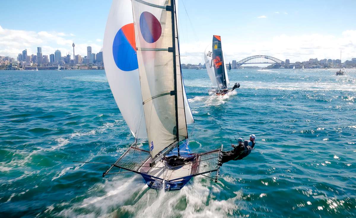 Leader Rag & Famish Hotel is chased by Yandoo down the first spinnaker run (SailMedia)